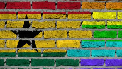 Dark brick wall texture - coutry flag and rainbow flag painted on wall - Ghana